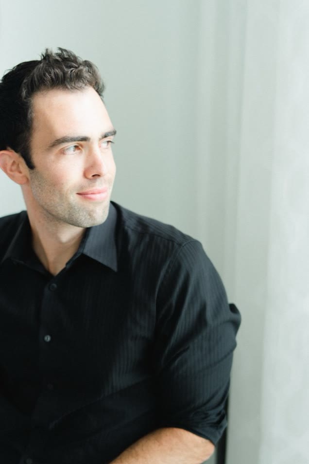 Nick Giulioni, seated, looking out a window.